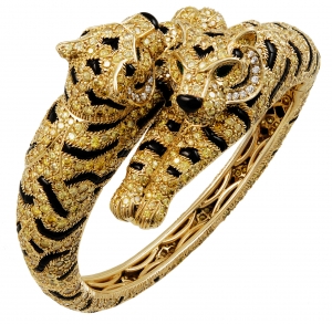 Cartier 18K yellow gold, fancy yellow diamonds, onyx, and emerald two-headed tiger bangle.