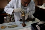 An Egyptian restorer fixes one the pieces that was broken by looters at the Egyptian Museum
