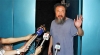 Dissident Chinese artist Ai Weiwei waves from the entrance of his studio after being released on bail in Beijing.