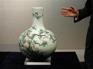 A fine and rare famille-rose &#039;&#039;peach&#039;&#039; vase, Tianqiuping, with a seal mark and period of Qianlong, which is estimated to fetch 10.3 to 15.4 million dollars, is shown during a Sotheby&#039;s preview in Hong Kong September 7, 2011.