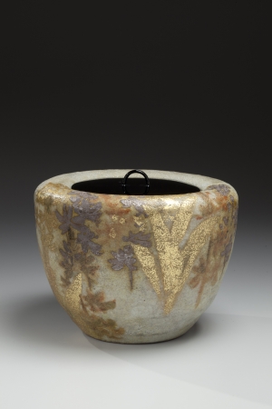 Kiyomizu Rokubei VI (1901-1980) Mizusashi (water jar) with floral patterning of an ebine or calanthe orchid and lacquer lid, ca. 1978. Kokisai-glazed stoneware with gold and silver, 6 3/8 x 8 1/2 in. Courtesy of Joan B. Mirviss Ltd.