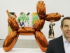 Jeff Koons poses in front of his works at the Whitney Museum of American Art.