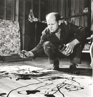     Artist Jackson Pollock dribbling sand on painting while working in his studio. Photo by Martha Holmes/The LIFE Picture Collection/Getty Images.