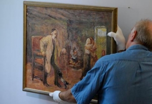 In this picture taken Wednesday Sept. 7, 2011 an employee adjusts the painting &quot;Die Heimkehr des Tobias&quot; ( The Return of Tobias) by German-Jewish painter Max Liebermann (1847-1935) at the Centrum Judaicum in Berlin. Israel&#039;s national museum has returned an impressionistic painting to the estate of its creator, the German-Jewish Max Liebermann. The work was looted from the Jewish Museum in Berlin, where it was on loan from the artist, in the 1930. Following the end of World War II, the American-based Jewish Restitution Successor Organization (JRSO) collected orphaned art and distributed the pieces to Jewish institutions worldwide. Liebermann&#039;s painting was one of more than 1,000 works the JRSO delivered in 1955 to the Bezalel National Museum, the precursor to the Israel Museum.