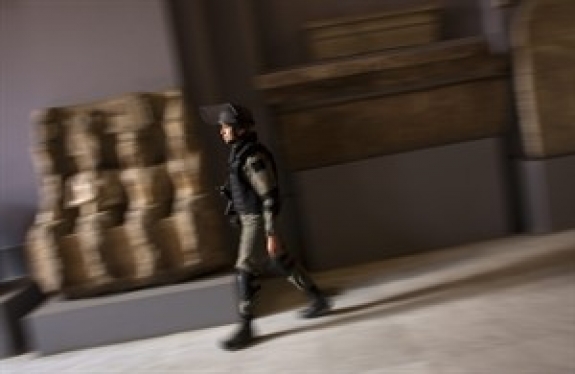 A member of the Egyptian special forces patrol on the main floor of the Egyptian Museum in Cairo, Egypt, Thursday, Feb. 10, 2011. Would-be looters broke into Cairo's famed Egyptian Museum on Saturday, Jan. 29, ripping the heads off two mummies and damaging about 75 small artifacts before being caught and detained by army soldiers. 