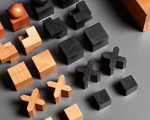 Josef Hartwig, Bauhaus Chess Set. Consisting of 32 pearwood pieces, each on a plinth, stained in natural and black, in beechwood box with folding cover and metal hinges.