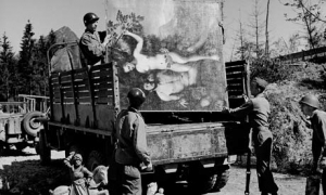 American soldiers load a truck with Nazi-looted artworks found hidden in a cave.