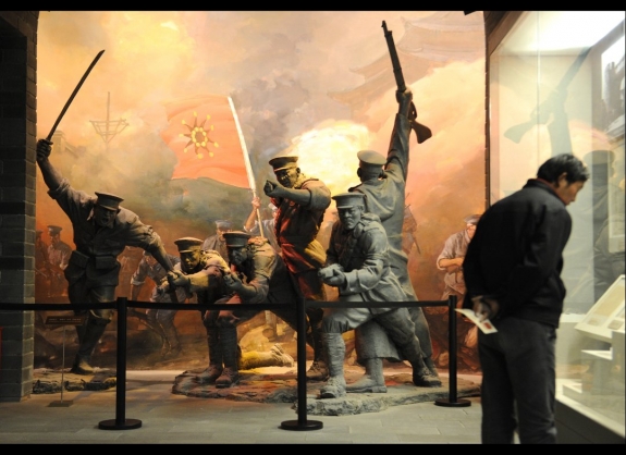 A man stands in front of a sculpture featuring the Wuchang Uprising in 1911 at the China National Museum. China reopened its national history museum on March 1 after a three-year facelift, but the sprawling look at the past fails to find room for some the country's most momentous -- and sensitive -- events. 
