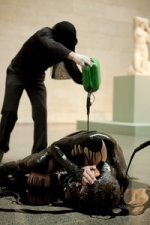 A protester belonging to the Liberate Tate group lies covered in an oil-like substance at Tate Britain in London. The protest marks the anniversary of the Deepwater Horizon explosion, with those taking part urging the Tate to take no more money from BP Plc