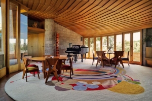 An interior view of the David and Gladys Wright House. The mahogany ceilings and floor-to-ceiling windows add warmth and light to the spiral home primarily constructed of concrete block.