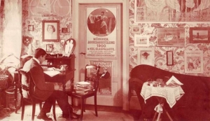 Poster collector Hans Sachs as a young man, surrounded by works from his collection.