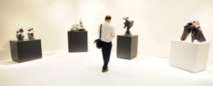 Visitors look at artwork at an auction preview in Hong Kong