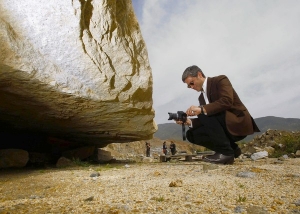 Michael Govan, director of LACMA, looks at artist Michael Heizer&#039;s boulder called &quot;Levitated Mass&quot; at the Stone Valley quarry in Riverside.