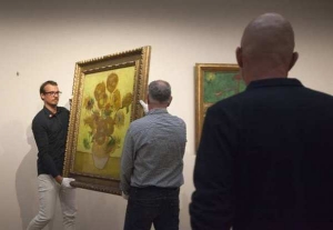 Curators remove Vincent van Gogh&#039;s famous &quot;Sunflowers&quot; painting from the wall of the Van Gogh Museum in Amsterdam.