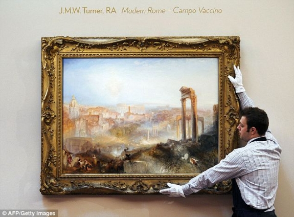 Under the hammer: A Sotheby's employee hangs the painting before the sale