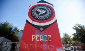 Shepard Fairey&#039;s controversial mural in Copenhagen, complete with graffiti. 