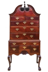 An early Chippendale bonnet top highboy of striking Cuban mahogany with claw and ball feet and Newport shell, original finial, c. 1765. Provenance with Olney family of Providence/Newport. Attribution: John Goddard, based upon the John Brown chair sold at Christie's, January 2002, lot 351, related claw and ball feet modeling. Courtesy of The Stanley Weiss Collection.